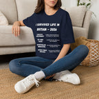 I Survived Life in Britain 2026 T-Shirt — Political Commentary Tee - Our Colours