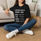 I Survived Life in Britain 2026 T-Shirt — Political Commentary Tee - Our Colours